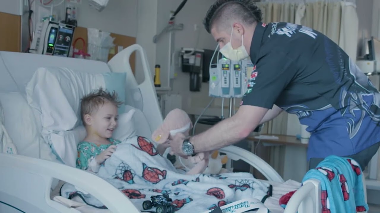 Monster Jam driver Bryce Kenny visits a child in Children's Minnesota