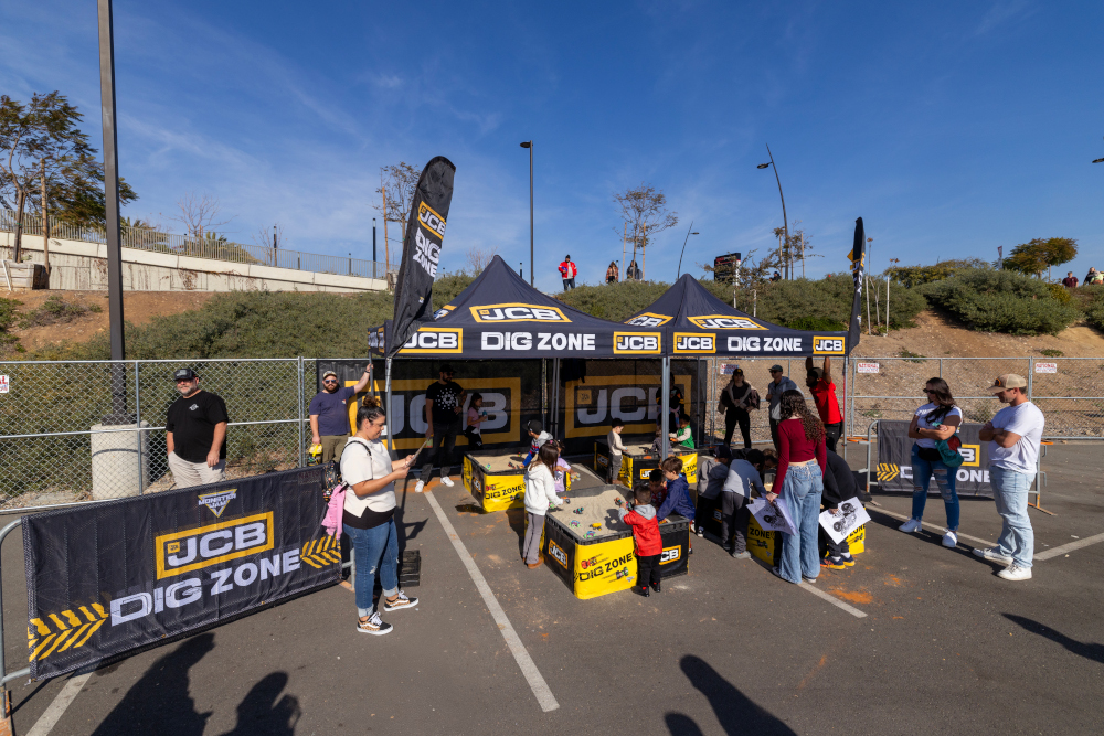 Fans enjoying the JCB Dig Zone at a Monster Jam Pit Party