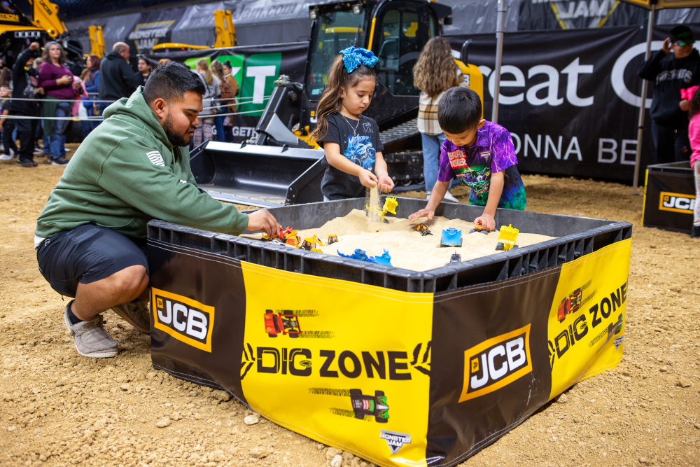 Fans enjoying the JCB Dig Zone at a Monster Jam Pit Party