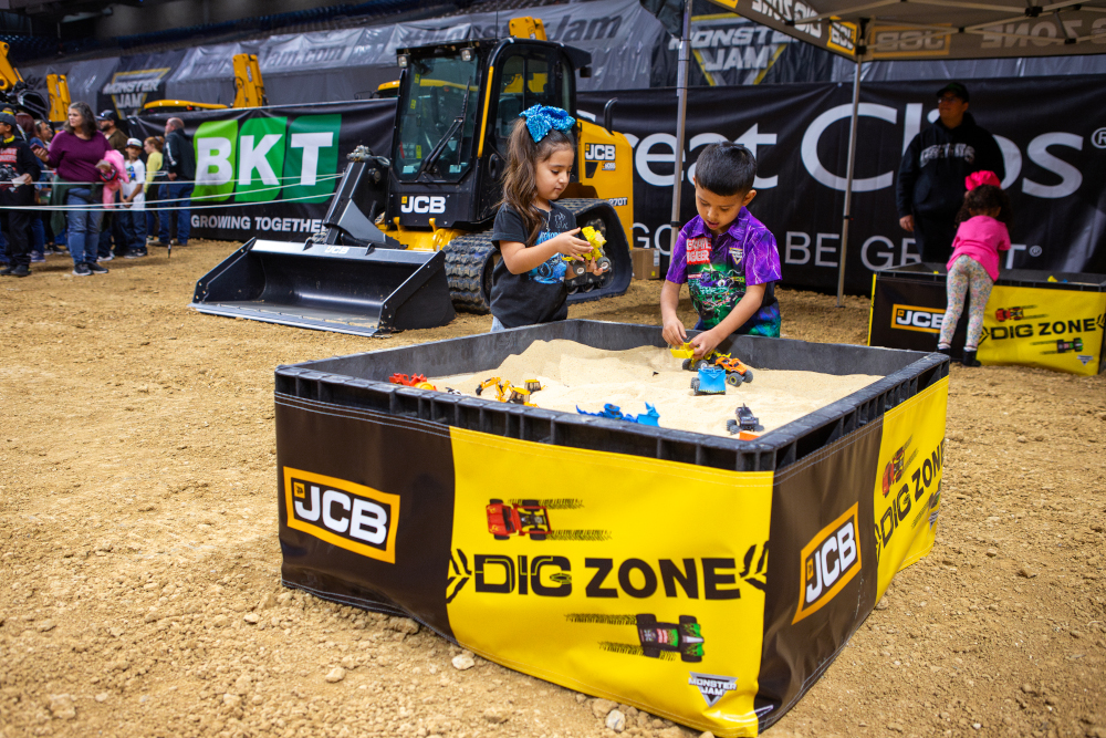 Fans enjoying the JCB Dig Zone at a Monster Jam Pit Party