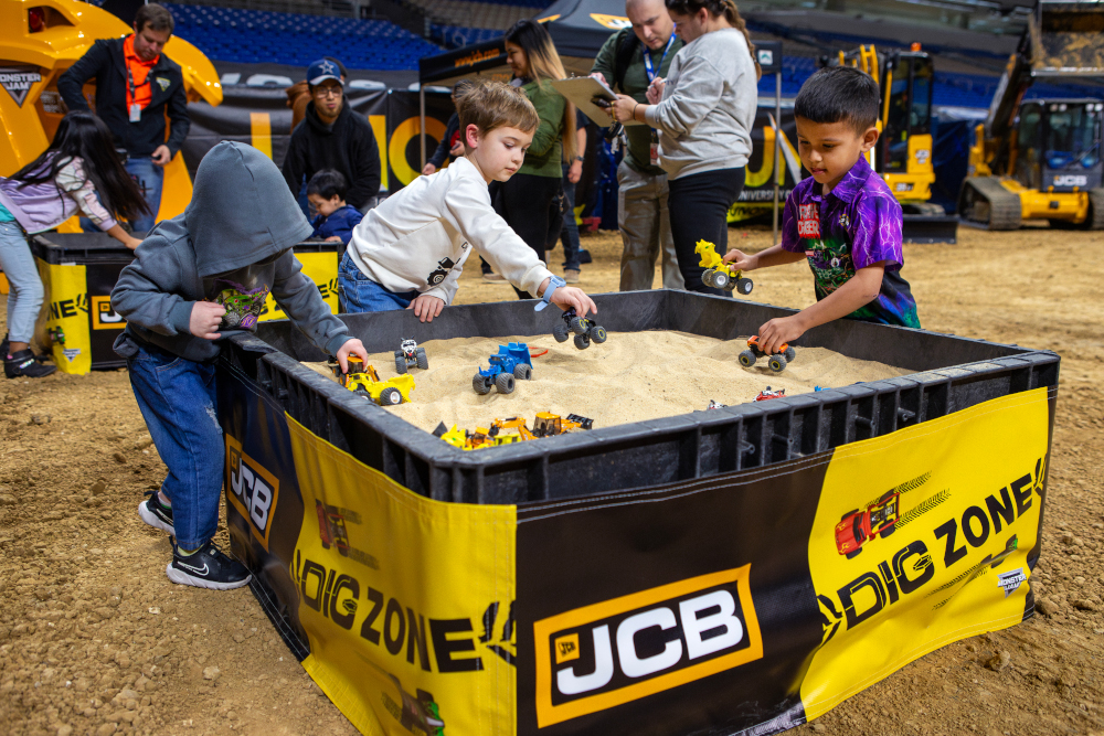 Fans enjoying the JCB Dig Zone at a Monster Jam Pit Party